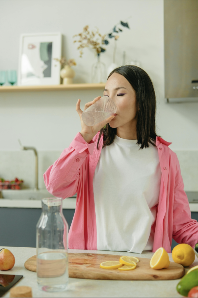 Person enjoying a refreshing glass of water.)